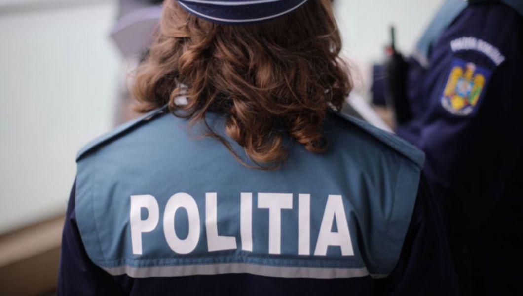 o polițistă îmbrăcată în uniformă stând cu spatele