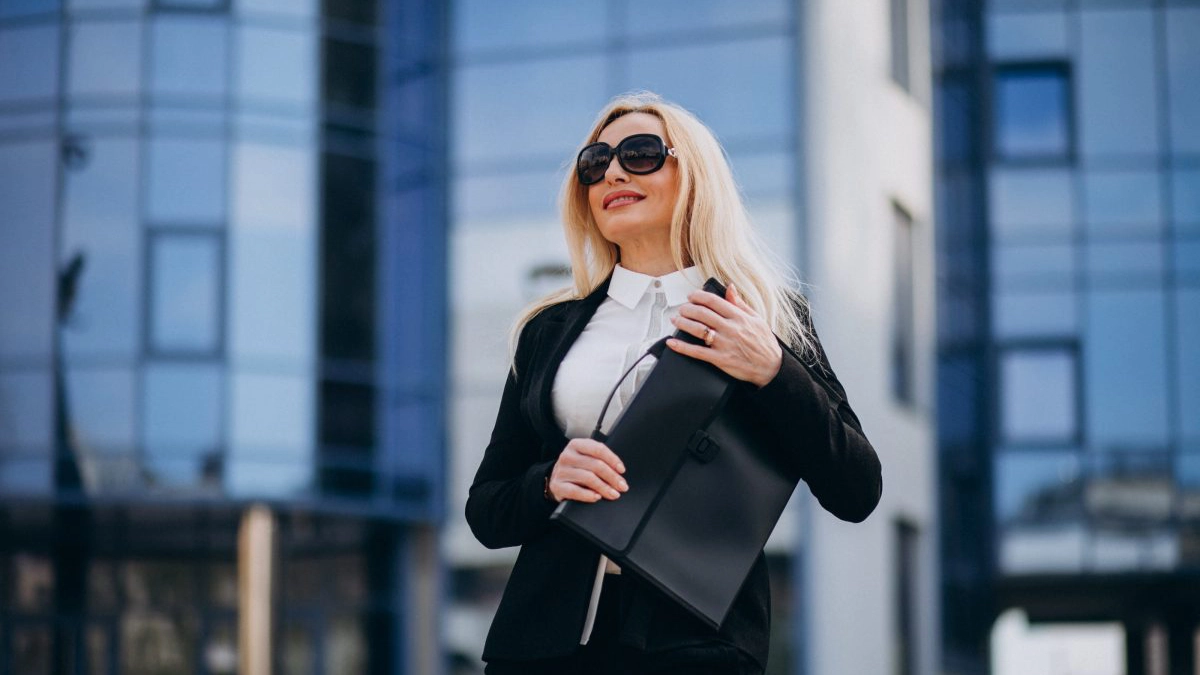 Middle aged business woman with suitcase by bussiness center