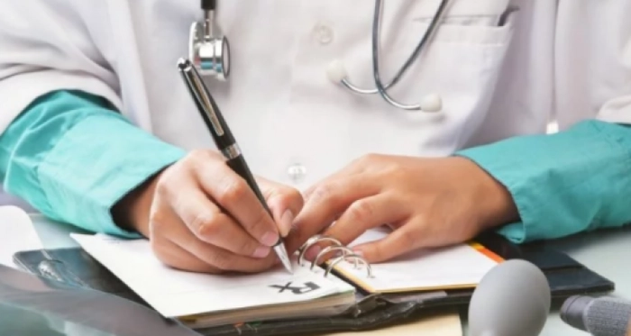 un medic de familie care scrie o reteta