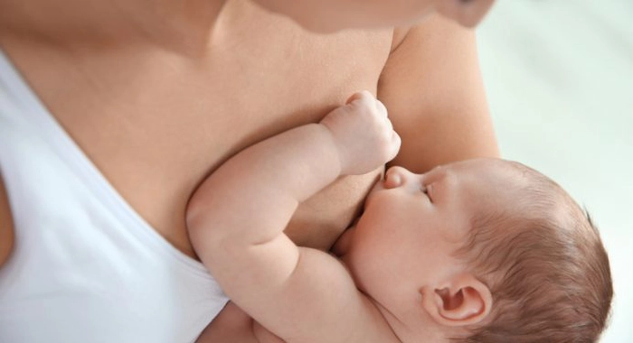 o femeie care alăptează un copil