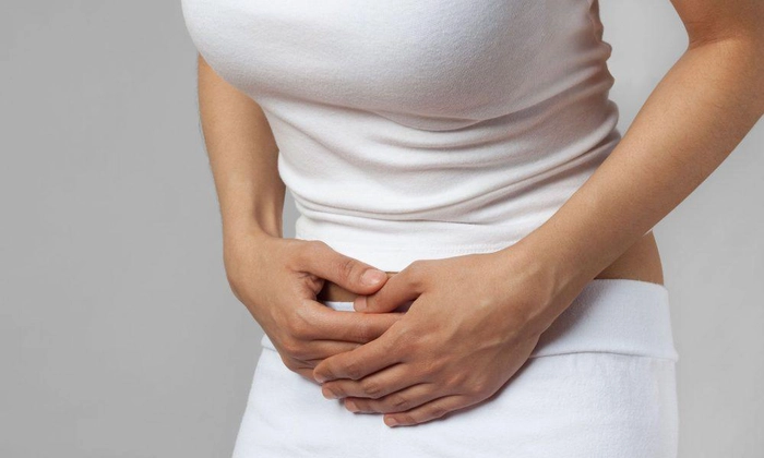 femeie care se tine de josul abdomenului din cauza fibromului uterin