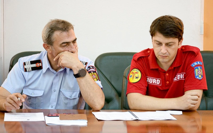un agent ISU langa un agent SMURD la o masa