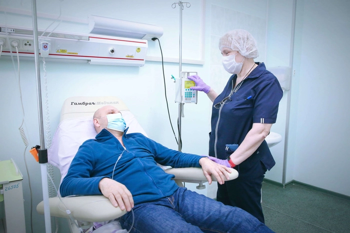 medic care pregateste aparatul pentru chimioterapie pentru un pacient bolnav de cancer