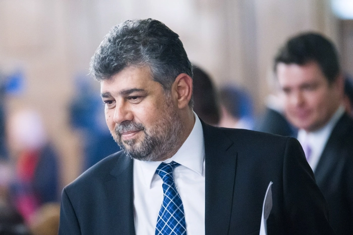 Marcel Ciolacu in timpul unei sedinte, inconjurat de membri de partid
