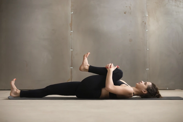 femeie care face exercitii pe un covoras de sport