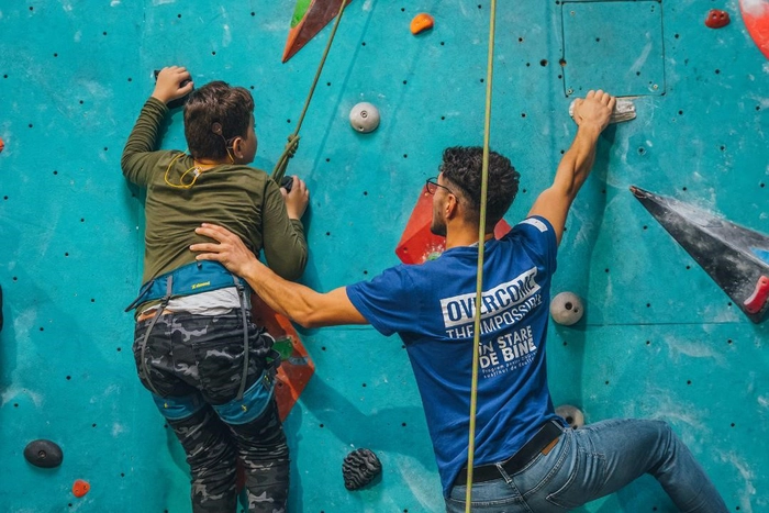 o poza cu doi oameni care practica escalada