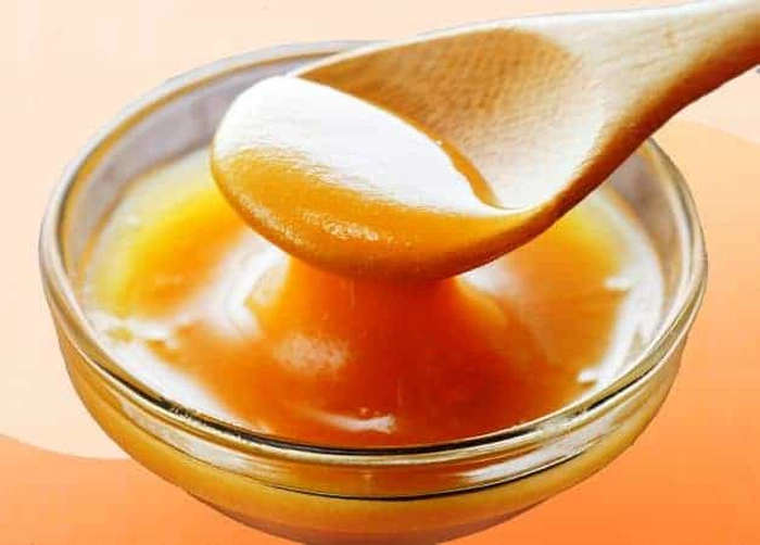 o linguriță de miere de manuka într-un castron mic