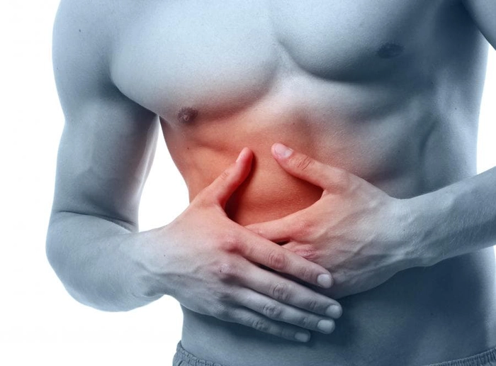 grafica barbat care se tine de partea dreapta a abdomenului din cauza durerii