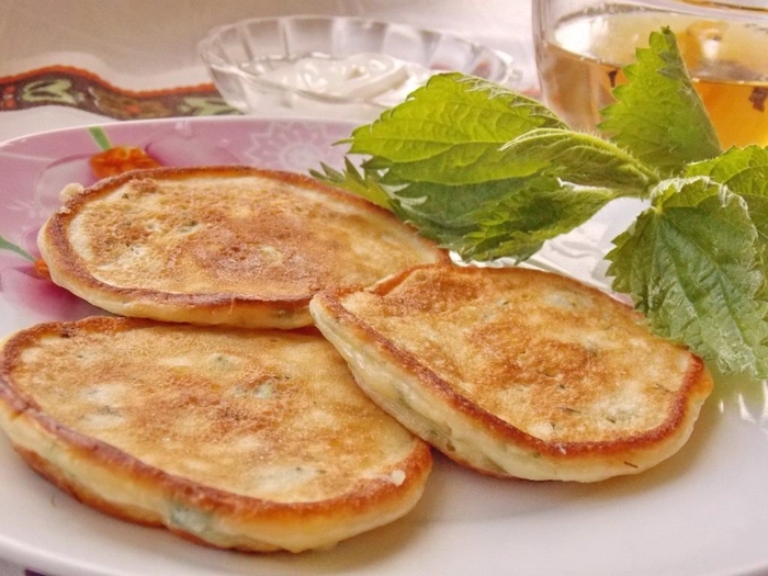 blinele pe o farfurie langa urzica proaspata