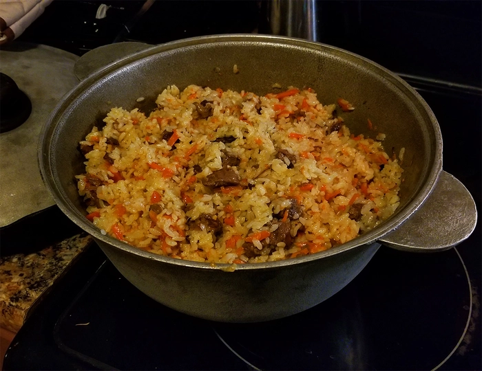 pilaf de orez intr-un ceaun pe o masa