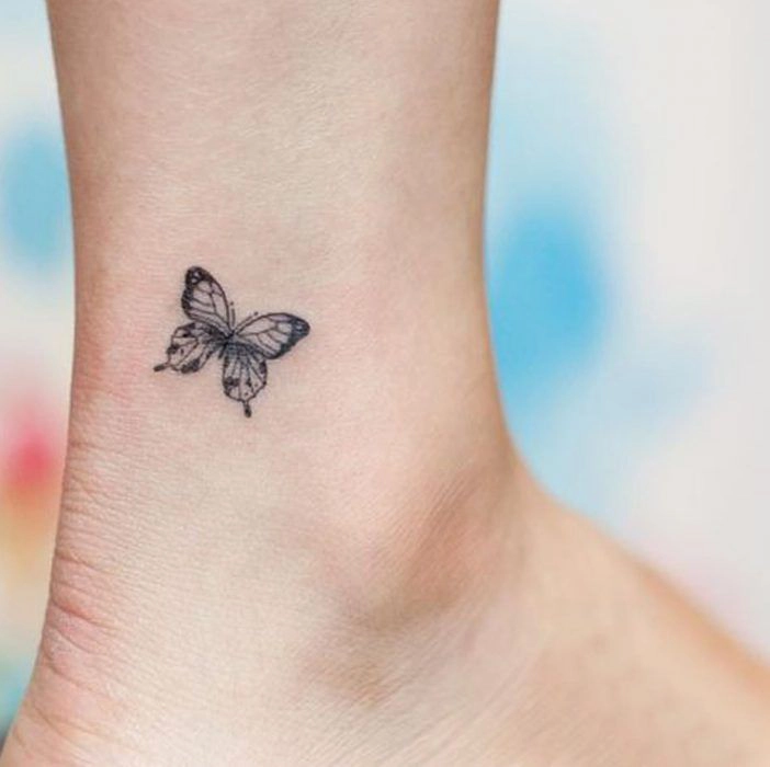 fluture tatuat pe piciorul unei persoane