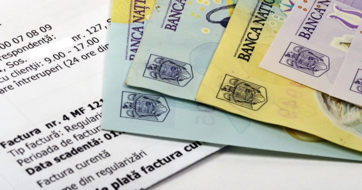 bancnote romanesti asezate pe o foaie de hartie pe care sunt tiparite datele unei facturi fiscale