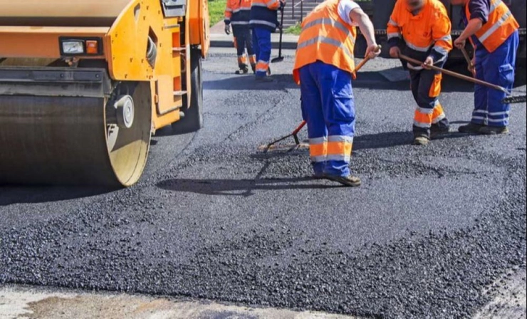 utilaj si muncitori care asfalteaza