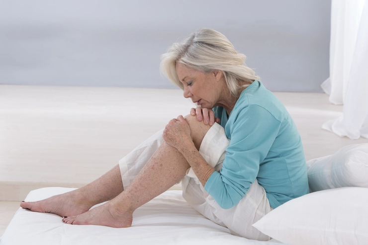 femeie care se confruntă cu dureri musculare la picioare