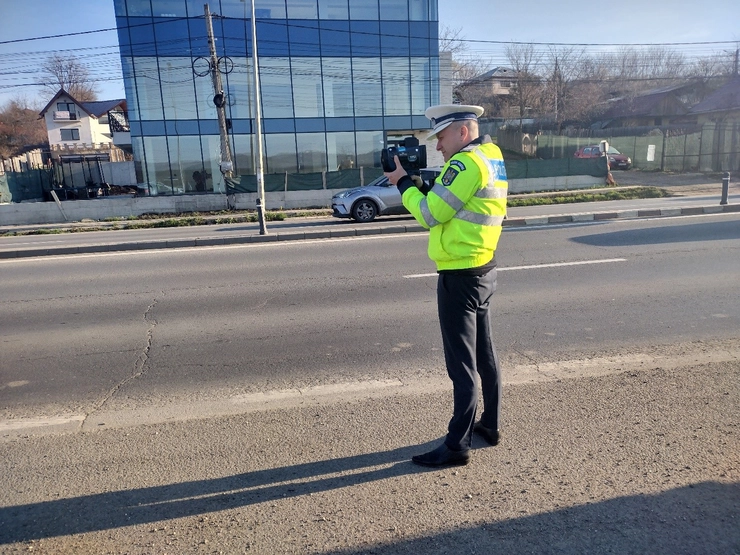  politist utilizeaza aparatul radar pe o strada