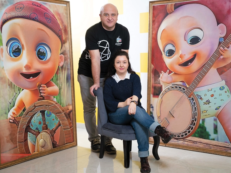 Cristina si Alexandru Badan si panouri cu copii în spatele lor