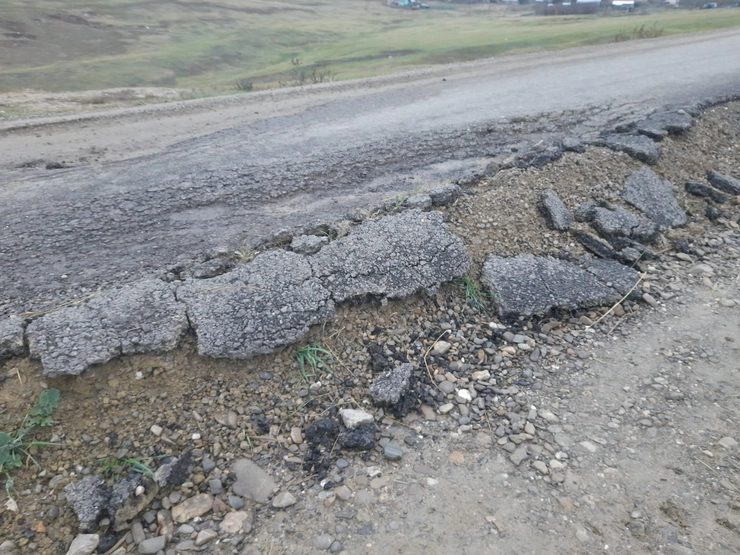 portiune de drum asfaltata si distrusa